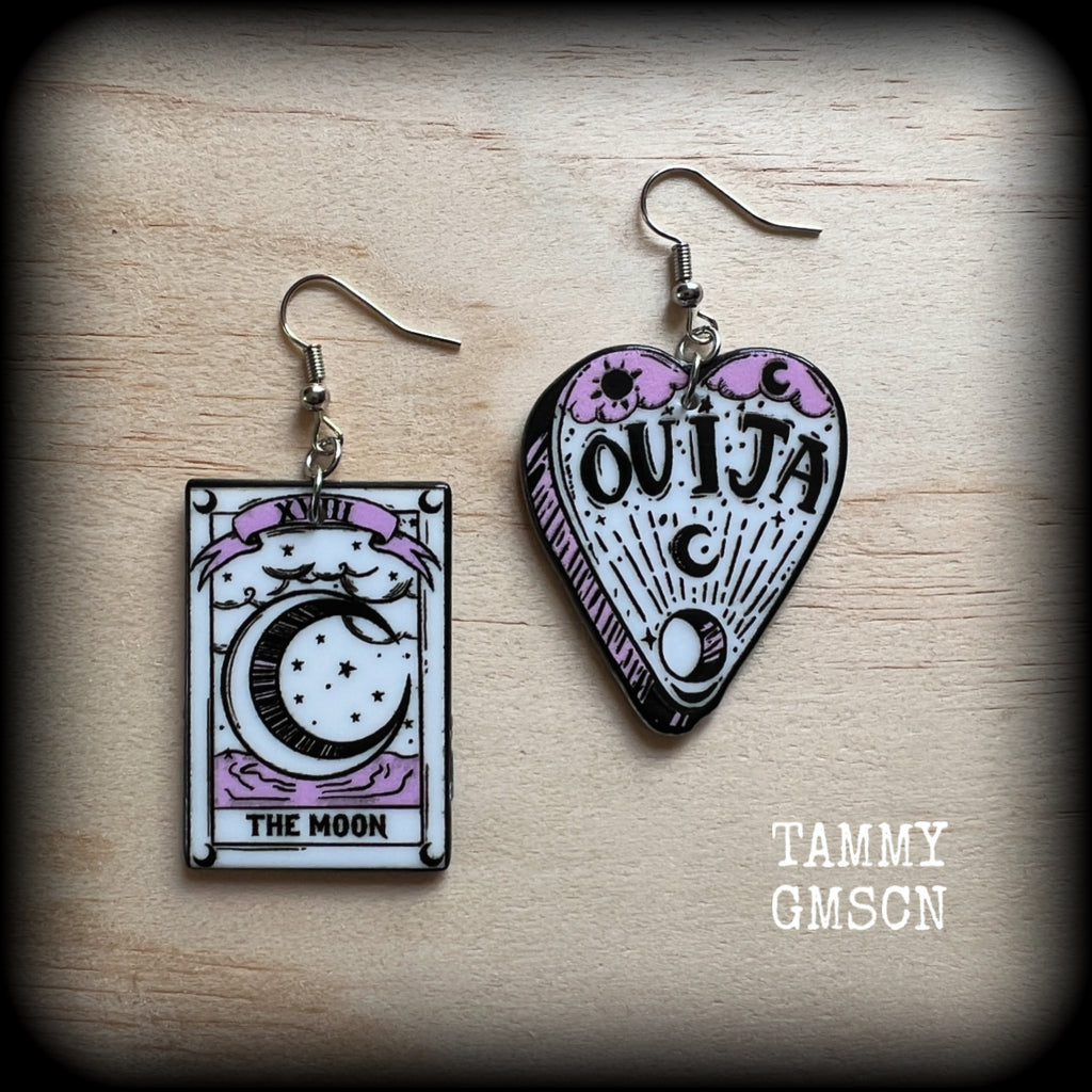 These awesome spooky cute pastel goth earrings feature baby pink and white ouija planchette and tarot card charms, are nice and light weight at only a few grams each, and are nice and dangly, measuring just on 6cms from tip to tip.

This pair has been made on with stainless steel french hooks, suitable for pierced ears. 