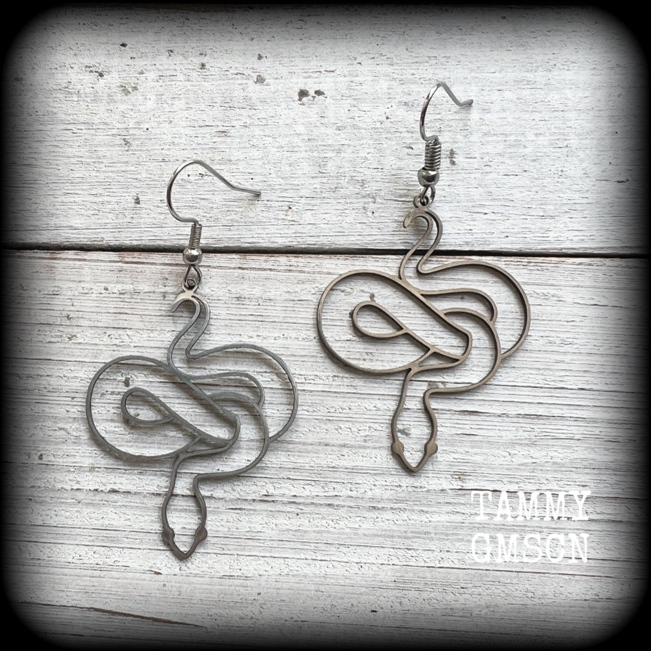 These earrings feature a gorgeous coiled stainless steel snake, measuring 6cms from tip to tip, and super lightweight at only a few grams each.

This pair have been made with stainless steel french hooks, suitable for pierced ears.