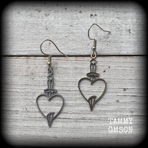This pair of earrings feature a classic punk stainless steel heart and dagger, measuring just over 5cms from tip to tip, these earrings are lovely and lightweight, weighing only a grams or two each.

This pair has been made on stainless steel french hooks, suitable for pierced ears.