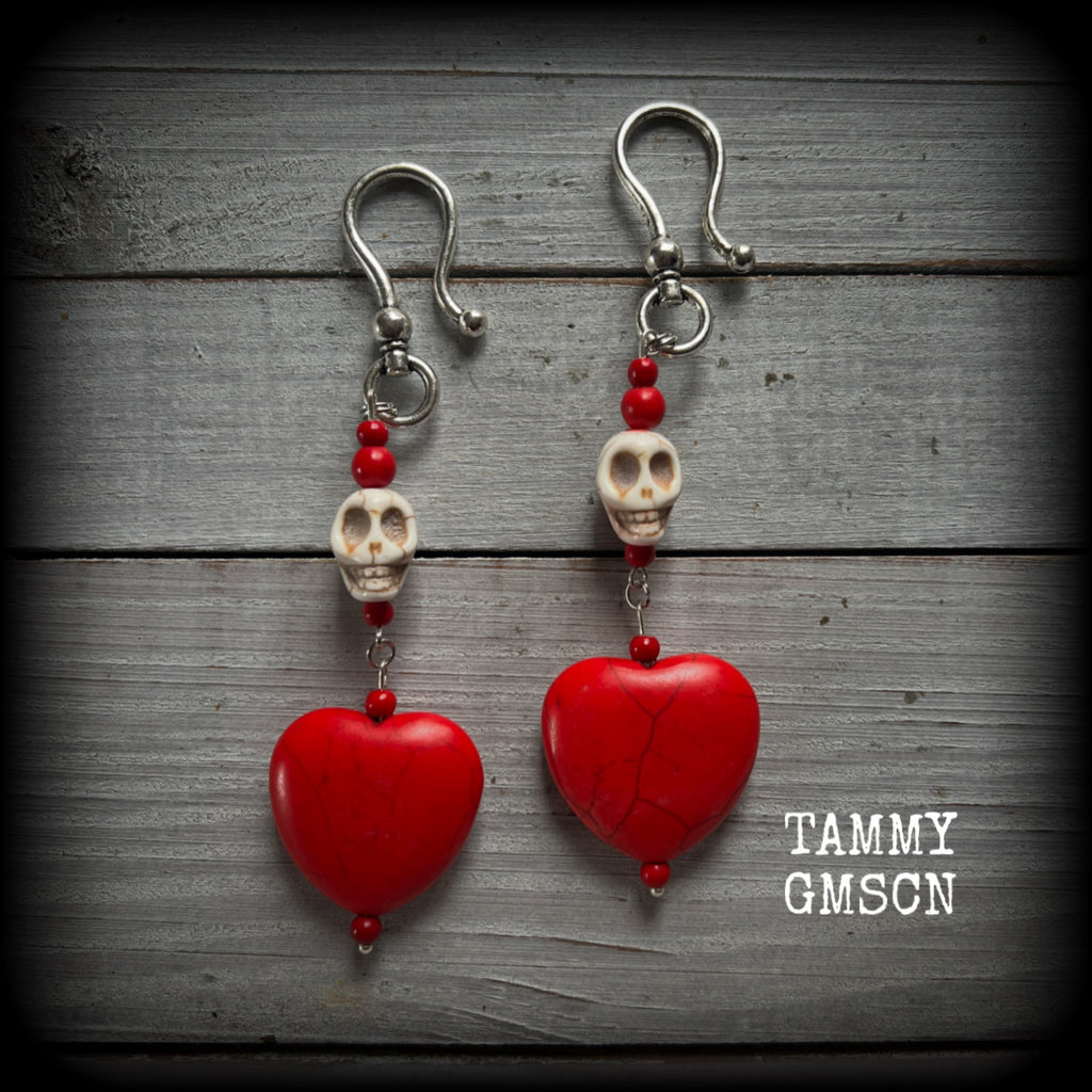 This pair of beautiful earrings features gorgeous big blood red stone hearts with bone white howlite stone skulls, measuring just under 12cm from tip to tip and weighing 18 grams each, these are nice and dangly.

This pair have been made with large antique silver shephard hooks, suitable for stretched lobes when worn with silicone earlets from 2 gauge (6mm).