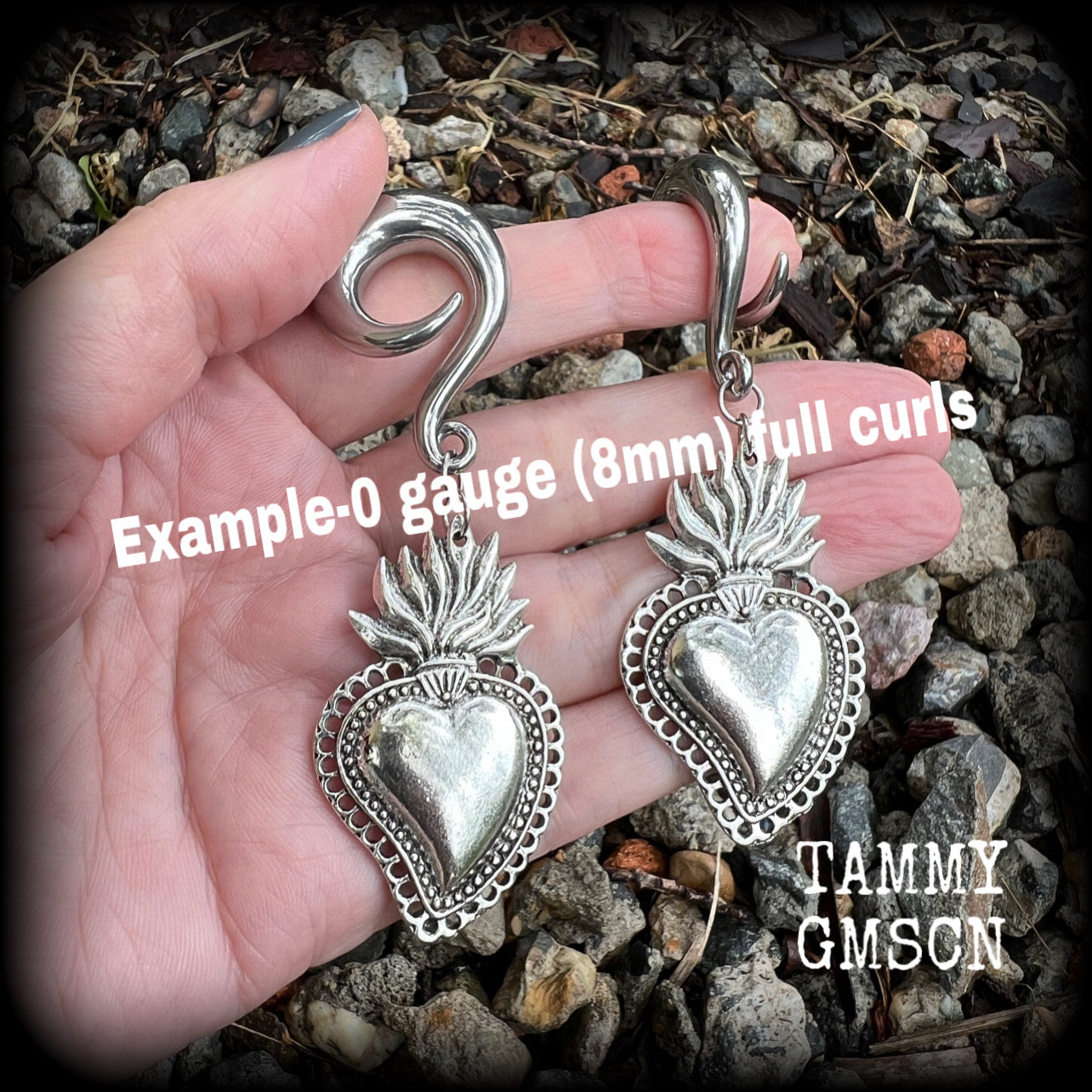These antique silver 'Sacred heart' gauged earrings feature a gorgeous antique silver milagros sacred heart pendant, measuring just on 9cms from tip to tip, and weighing approx 22 grams each.

This pair has been made on 0 gauge (8mm) surgical steel full curl hooks, suitable for stretched lobes.