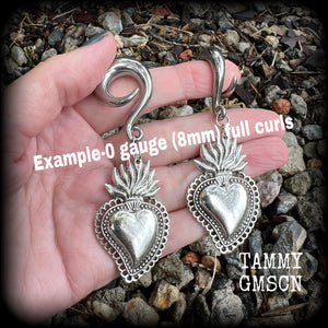 These antique silver 'Sacred heart' gauged earrings feature a gorgeous antique silver milagros sacred heart pendant, measuring just on 9cms from tip to tip, and weighing approx 22 grams each.

This pair has been made on 0 gauge (8mm) surgical steel full curl hooks, suitable for stretched lobes.