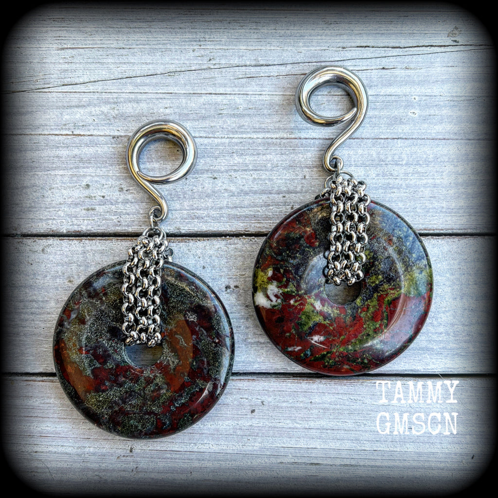 This is a pair of ear weights made from large Dragons blood jasper donut gemstones, cradled in stainless steel chain attached to a gauged hook for stretched lobes.