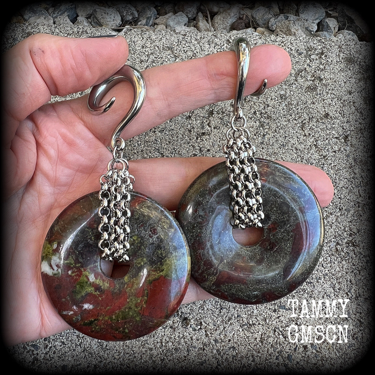 This is a pair of ear weights made from large Dragons blood jasper donut gemstones, cradled in stainless steel chain attached to a gauged hook for stretched lobes.