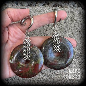 This is a pair of ear weights made from large Dragons blood jasper donut gemstones, cradled in stainless steel chain attached to a gauged hook for stretched lobes.