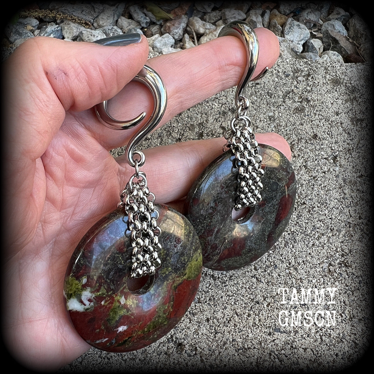 This is a pair of ear weights made from large Dragons blood jasper donut gemstones, cradled in stainless steel chain attached to a gauged hook for stretched lobes.