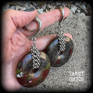 This is a pair of ear weights made from large Dragons blood jasper donut gemstones, cradled in stainless steel chain attached to a gauged hook for stretched lobes.