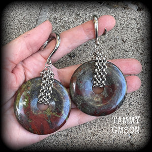 This is a pair of ear weights made from large Dragons blood jasper donut gemstones, cradled in stainless steel chain attached to a gauged hook for stretched lobes.