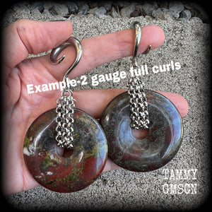 This is a pair of ear weights made from large Dragons blood jasper donut gemstones, cradled in stainless steel chain attached to a gauged hook for stretched lobes.