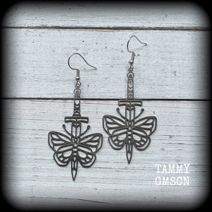 This pair of stainless steel earrings features a classic punk butterfly and dagger tattoo design, measuring just on 7cms from tip to tip, and weighing only a grams or two each.

This pair has been made on stainless steel french hooks, suitable for pierced ears.