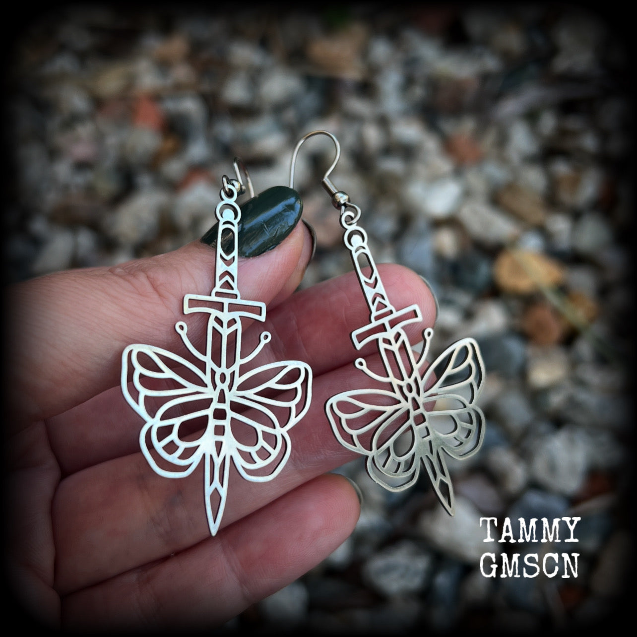 This pair of stainless steel earrings features a classic punk butterfly and dagger tattoo design, measuring just on 7cms from tip to tip, and weighing only a grams or two each.

This pair has been made on stainless steel french hooks, suitable for pierced ears.