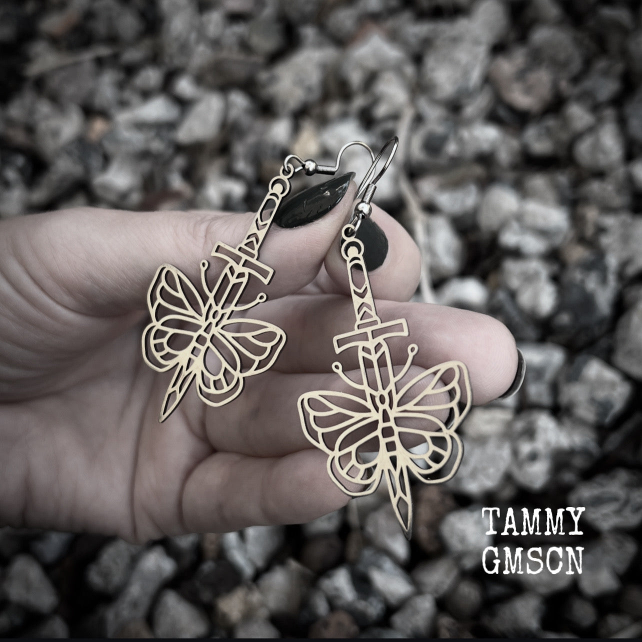 This pair of stainless steel earrings features a classic punk butterfly and dagger tattoo design, measuring just on 7cms from tip to tip, and weighing only a grams or two each.

This pair has been made on stainless steel french hooks, suitable for pierced ears.