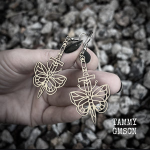 This pair of stainless steel earrings features a classic punk butterfly and dagger tattoo design, measuring just on 7cms from tip to tip, and weighing only a grams or two each.

This pair has been made on stainless steel french hooks, suitable for pierced ears.
