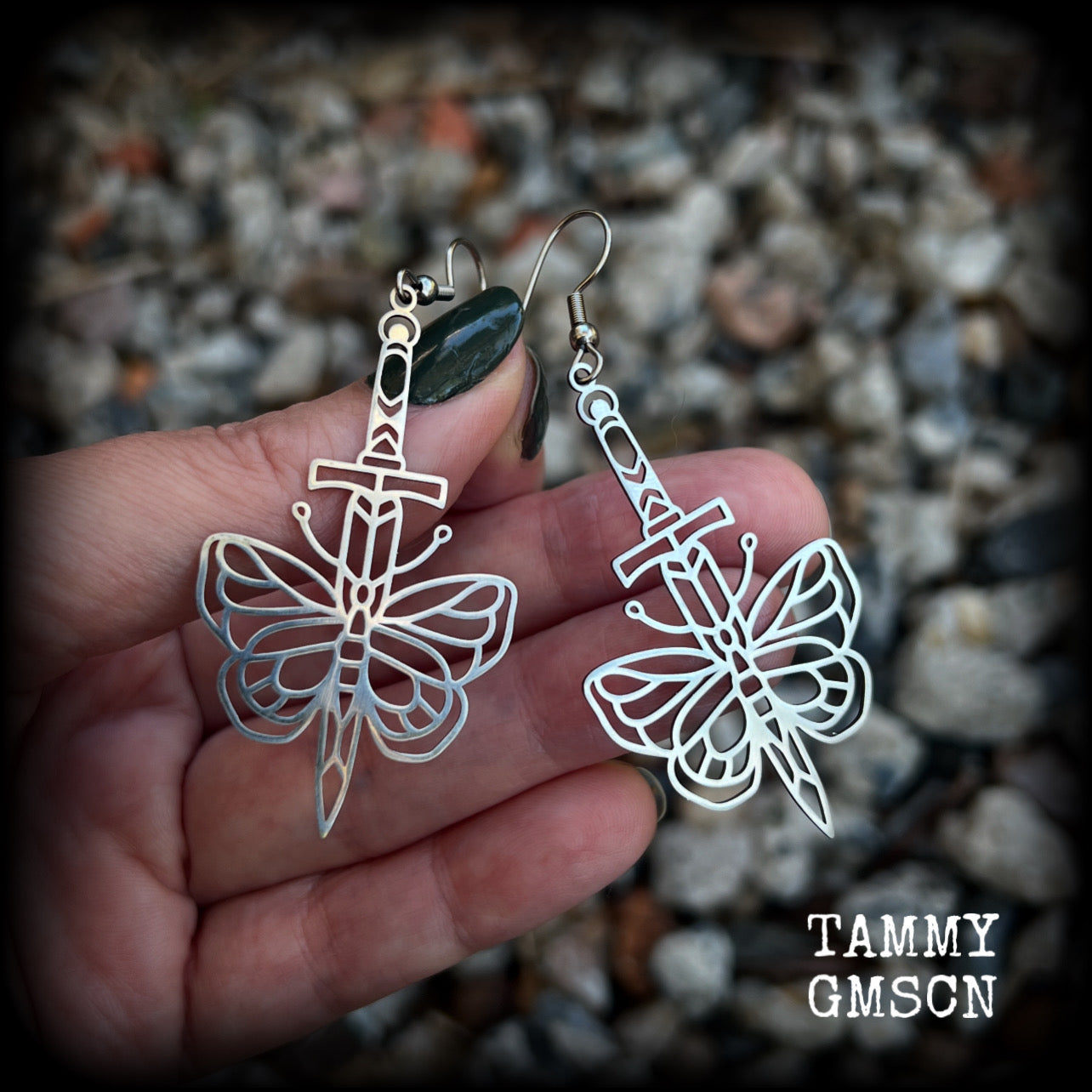 This pair of stainless steel earrings features a classic punk butterfly and dagger tattoo design, measuring just on 7cms from tip to tip, and weighing only a grams or two each.

This pair has been made on stainless steel french hooks, suitable for pierced ears.