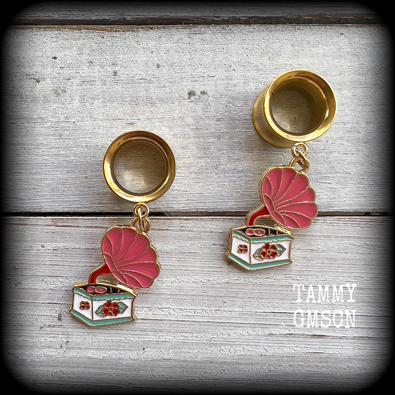 These cute little earrings have been made with pink and gold enamel gramophone charms, weighing only 5 grams each and measuring approx 4cms from tip to tip.

This pair has been made with 1/2" gauge (12mm) surgical steel screw fit earlets, for stretched lobes.