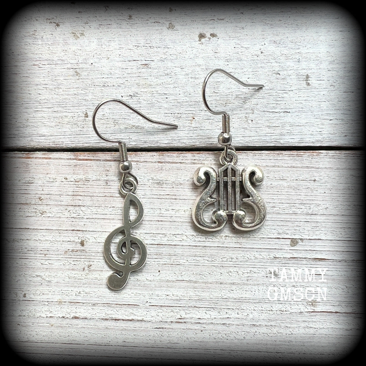 This awesome pair of earrings features antique silver treble clef with a vintage lyre music stand charm, are nice and lightweight weighing only a few grams each, and measure approx 4cms from tip to tip.

This pair has been made on stainless steel french hooks, suitable for pierced ears.
