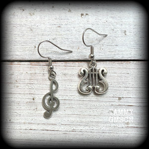 This awesome pair of earrings features antique silver treble clef with a vintage lyre music stand charm, are nice and lightweight weighing only a few grams each, and measure approx 4cms from tip to tip.

This pair has been made on stainless steel french hooks, suitable for pierced ears.
