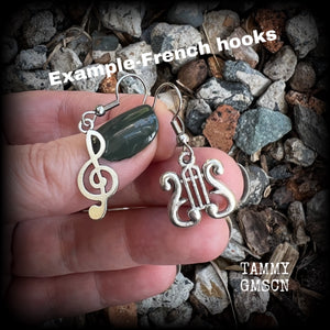 This awesome pair of earrings features antique silver treble clef with a vintage lyre music stand charm, are nice and lightweight weighing only a few grams each, and measure approx 4cms from tip to tip.

This pair has been made on stainless steel french hooks, suitable for pierced ears.
