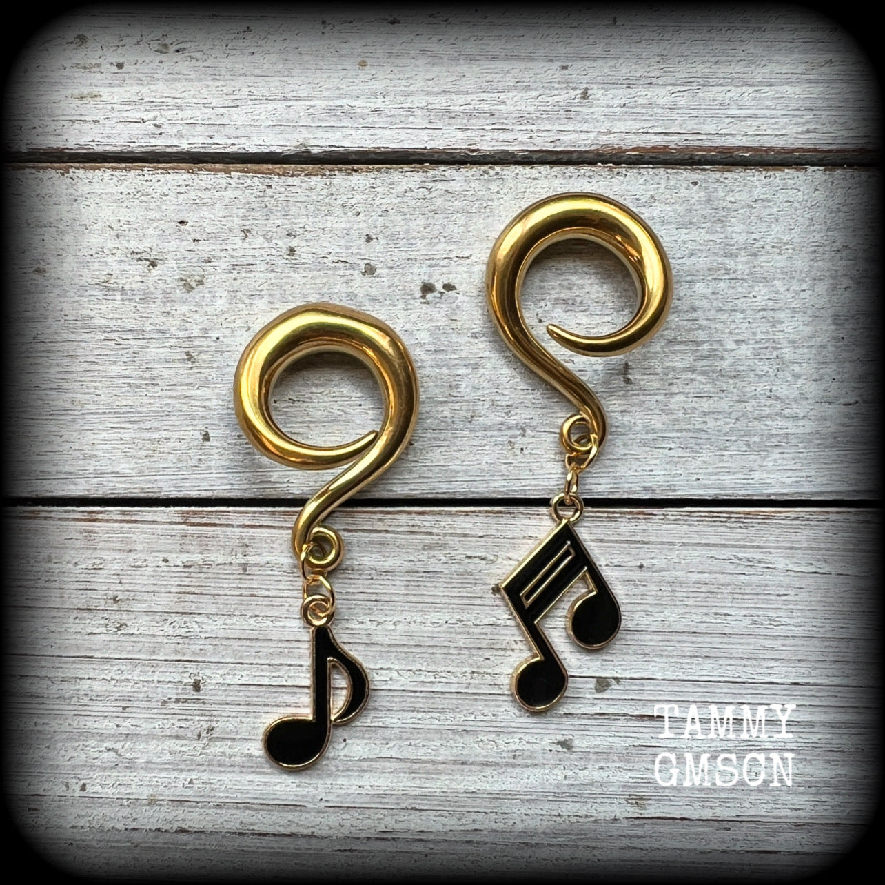 These awesome gauged earrings feature gorgeous antique gold and black enamel music notes, not too heavy at approx 8 grams a piece, and nice and dangly at just on 6cms from tip to tip.

This pair has been made on 2 gauge (6mm) surgical steel full curl hooks, suitable for stretched lobes.