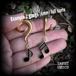These awesome gauged earrings feature gorgeous antique gold and black enamel music notes, not too heavy at approx 8 grams a piece, and nice and dangly at just on 6cms from tip to tip.

This pair has been made on 2 gauge (6mm) surgical steel full curl hooks, suitable for stretched lobes.