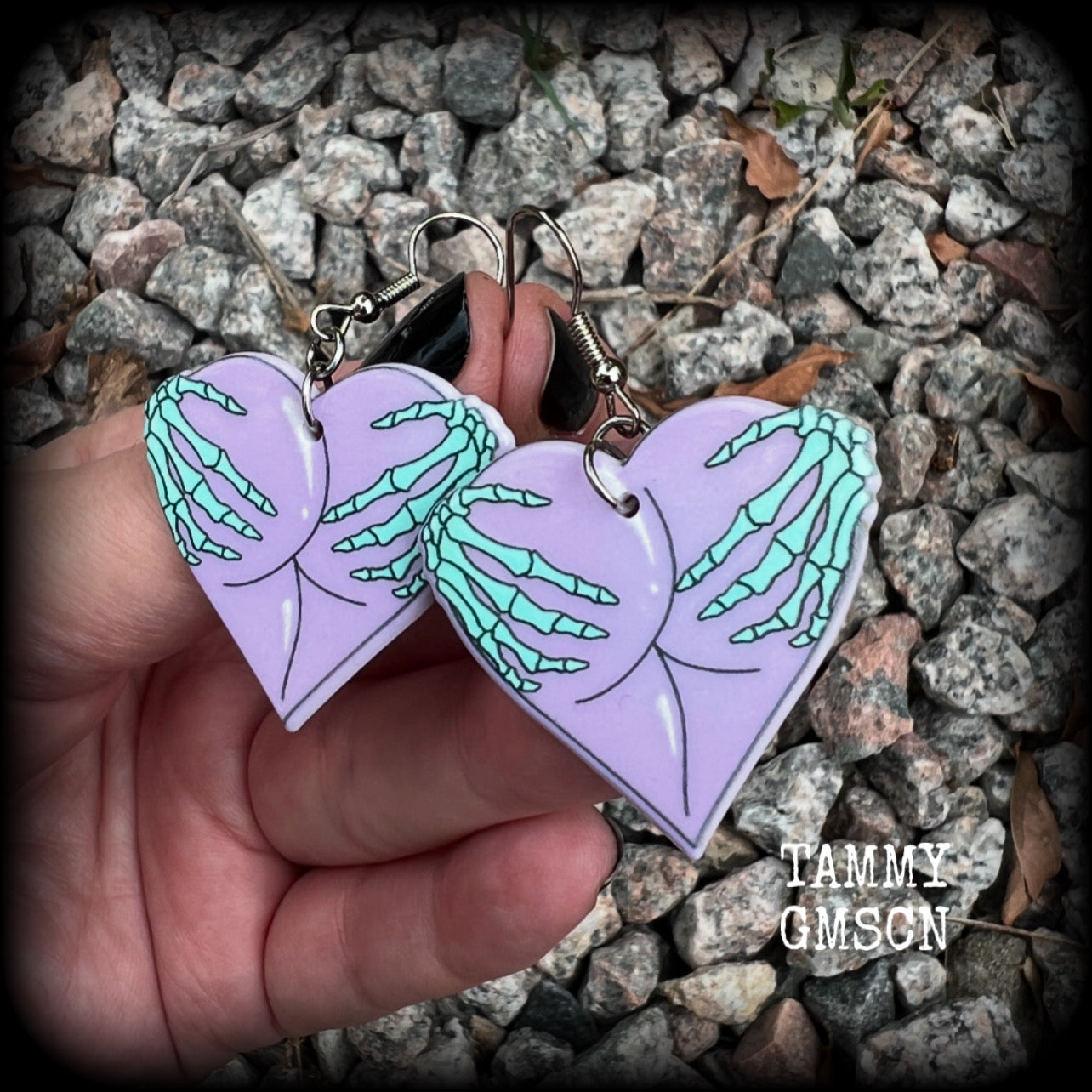 These cheeky pastel goth halloween earrings feature light weight skeleton hands grabbing a pair of purple butt cheeks, super lightweight at only a few grams each, and nice and dangly at 6cms from tip to tip.  This pair has made on stainless steel french hooks, suitable for pierced ears.