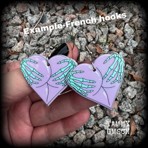 These cheeky pastel goth halloween earrings feature light weight skeleton hands grabbing a pair of purple butt cheeks, super lightweight at only a few grams each, and nice and dangly at 6cms from tip to tip.  This pair has made on stainless steel french hooks, suitable for pierced ears.