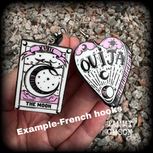 These awesome spooky cute pastel goth earrings feature baby pink and white ouija planchette and tarot card charms, are nice and light weight at only a few grams each, and are nice and dangly, measuring just on 6cms from tip to tip.  This pair has been made on with stainless steel french hooks, suitable for pierced ears.