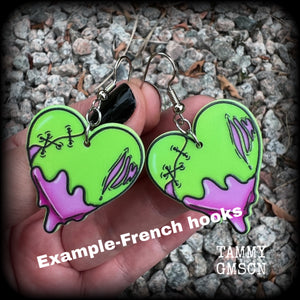 These awesome 'Zombie heart' earrings feature light weight purple and green acrylic rotting zombie hearts, are super lightweight at only 3 grams each, and are nice and dangly, measuring just under 6cms from tip to tip.  This pair has made on stainless steel french hooks, suitable for pierced ears or stretched lobes.