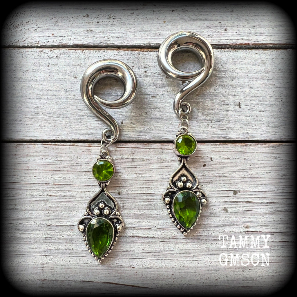 This pair of earrings features gorgeous green quartz and peridot gemstones in a boho antique silver setting, weighing approx 19 grams a piece and measuring just on 8.5cms from tip to tip.

This pair have been made on 0 gauge (8mm) surgical steel full curl hooks, to be worn in stretched lobes.
