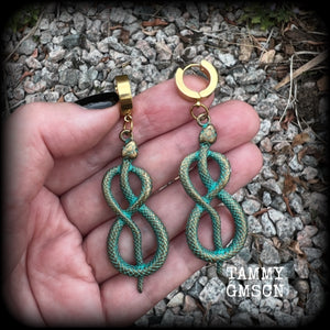 These awesome earrings feature antique bronze snake twisted into an infinity symbol, weighing in at 8 grams each, and measuring approx 7.5cms from tip to tip.  This pair have been made on stainless steel huggie ear cuffs, suitable for pierced ears.