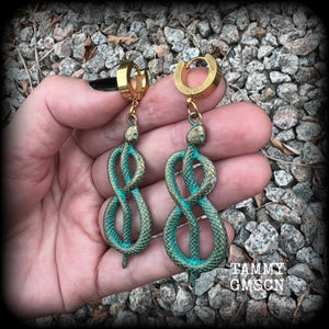 These awesome earrings feature antique bronze snake twisted into an infinity symbol, weighing in at 8 grams each, and measuring approx 7.5cms from tip to tip.  This pair have been made on stainless steel huggie ear cuffs, suitable for pierced ears.
