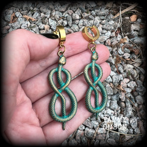These awesome earrings feature antique bronze snake twisted into an infinity symbol, weighing in at 8 grams each, and measuring approx 7.5cms from tip to tip.  This pair have been made on stainless steel huggie ear cuffs, suitable for pierced ears.