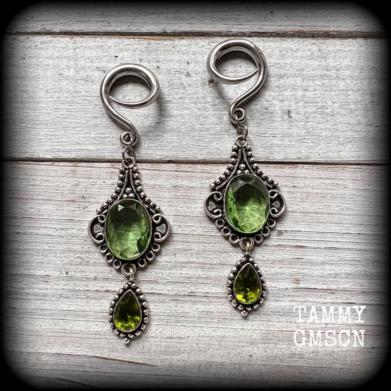 This pairof Peridot and antique silver gauged earrings weigh approx 9 grams a piece, nice and lightweight, and measuring approx 8cms from tip to tip.
These have been made on 6 gauge (4mm) surgical steel full curl hooks, to be worn in stretched lobes.