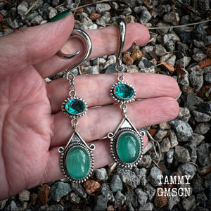 This pair of earrings features gorgeous green topaz and cats eye gemstones in a beautiful boho antique silver setting, weighing approx 14 grams a piece and measuring just on 8.5cms from tip to tip.  This pair have been made on 2 gauge (6mm) surgical steel full curls, to be worn in stretched lobes.