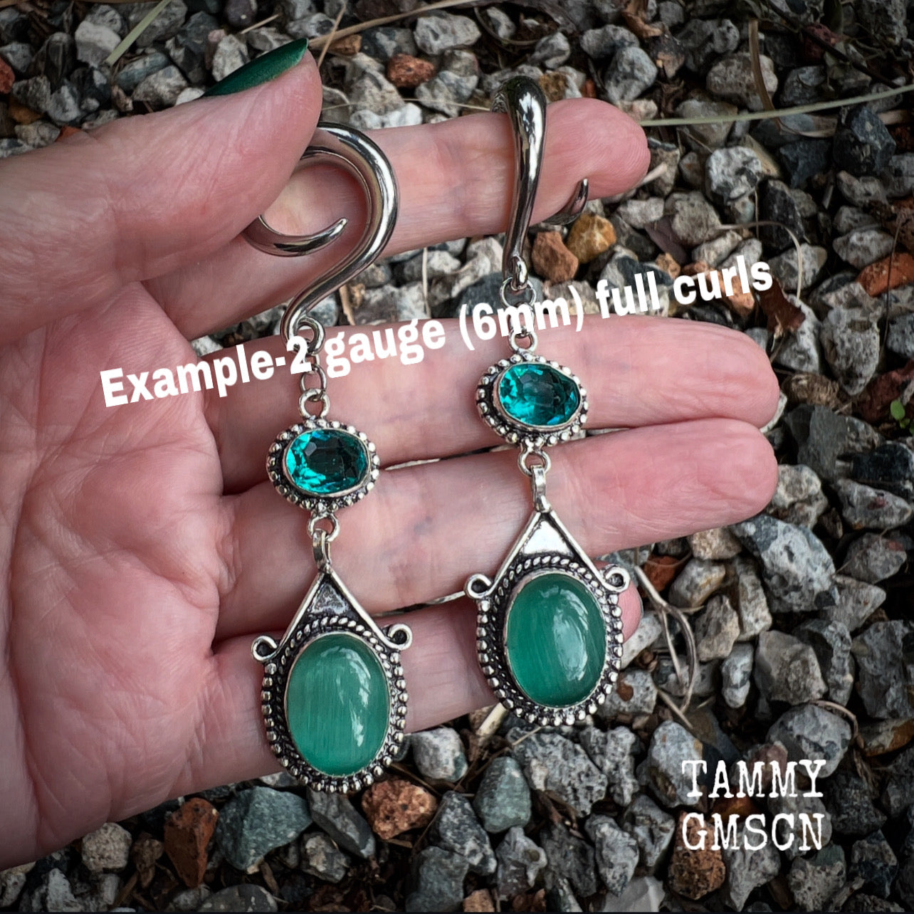 This pair of earrings features gorgeous green topaz and cats eye gemstones in a beautiful boho antique silver setting, weighing approx 14 grams a piece and measuring just on 8.5cms from tip to tip.  This pair have been made on 2 gauge (6mm) surgical steel full curls, to be worn in stretched lobes.