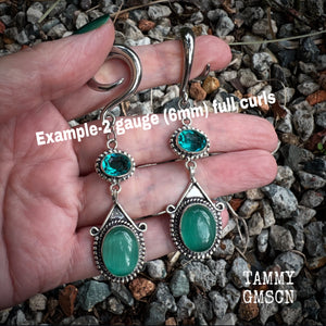 This pair of earrings features gorgeous green topaz and cats eye gemstones in a beautiful boho antique silver setting, weighing approx 14 grams a piece and measuring just on 8.5cms from tip to tip.  This pair have been made on 2 gauge (6mm) surgical steel full curls, to be worn in stretched lobes.