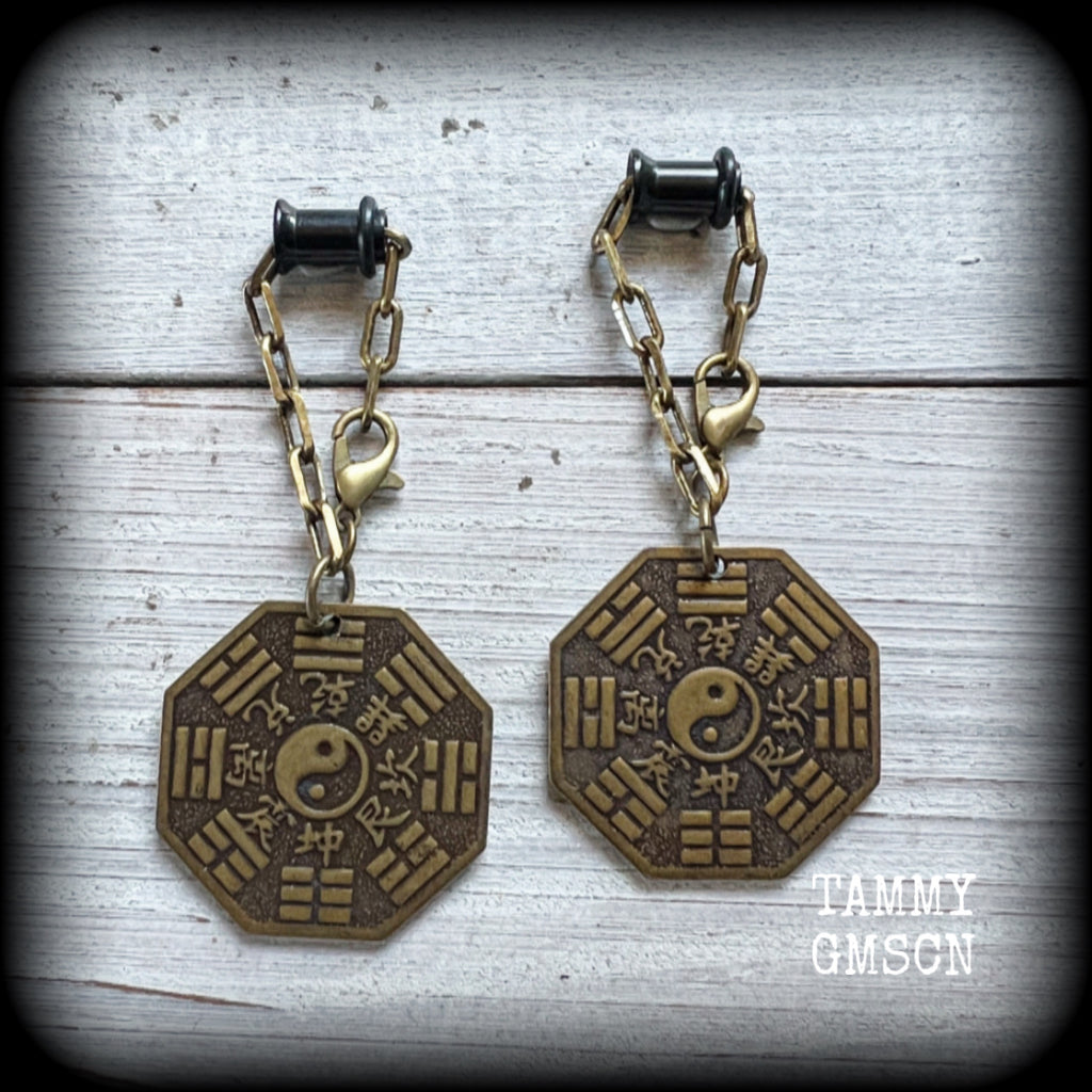 These unique tunnel dangles feature brass Tai Shang Lao Jun pendants, a type of Chinese Taoist pendant with the front side featuring the Chinese Bagua for protection, while the other side showcases a Chinese Taoism design for great protection.

🔥 These pendants are associated with Tai Shang Lao Jun, a prominent deity in Taoism, and are believed to offer protection and good fortune🔥

This pair weighs approx 10 grams each, and measuring 6.5cms from tip to tip.