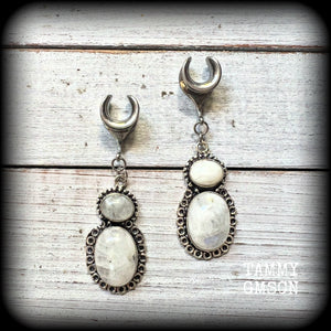 This pair of Rainbow moonstone gauged earrings feature gorgeous polished gemstones in a beautiful boho antique silver setting, lovely and dangly measuring 6.5cms from tip to tip, and weighing approx 10 grams each.

These earrings have been made on 00 gauge (10mm) surgical steel cradles, to be worn in stretched lobes.