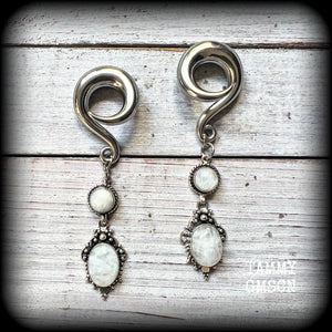 These beautiful boho Rainbow moonstone earrings are made with gorgeous polished gemstones, lovely and dangly measuring approx 8.5cms from tip to tip, and weighing approx 19 grams each.

These earrings have been made on 0 gauge (8mm) surgical steel full curl hooks, to be worn in stretched lobes.