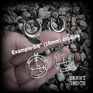 These gorgeous stainless steel earrings feature the Sigil of Lilith as it appears in The Lesser Key of Solomon, and are lovely and light weight, weighing only 5 grams each, and measure just under 6 cms from tip to tip.
This pair has been made on 5/8” gauge (16mm) surgical steel cradles, for stretched lobes.