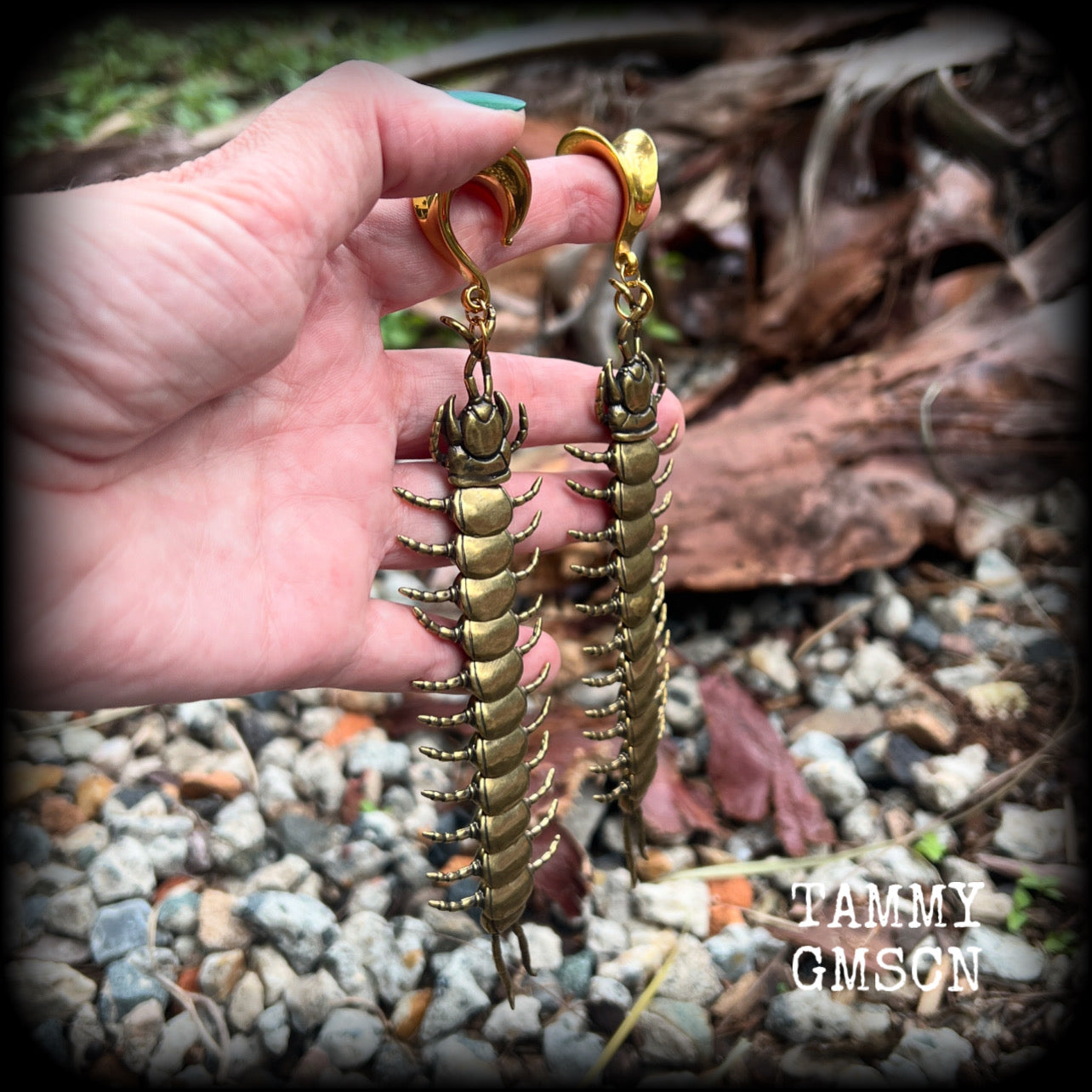 These awesome brass centipede ear hangers feature gorgeous brass invertebtrate pendants, measuring just over 17cms from tip to tip, and weighing approx 55 grams each, nice and dangly with a nice bit of weight.

This pair has been made on 5/8” gauge (16mm) titanium coated surgical steel saddles, suitable for stretched lobes.

