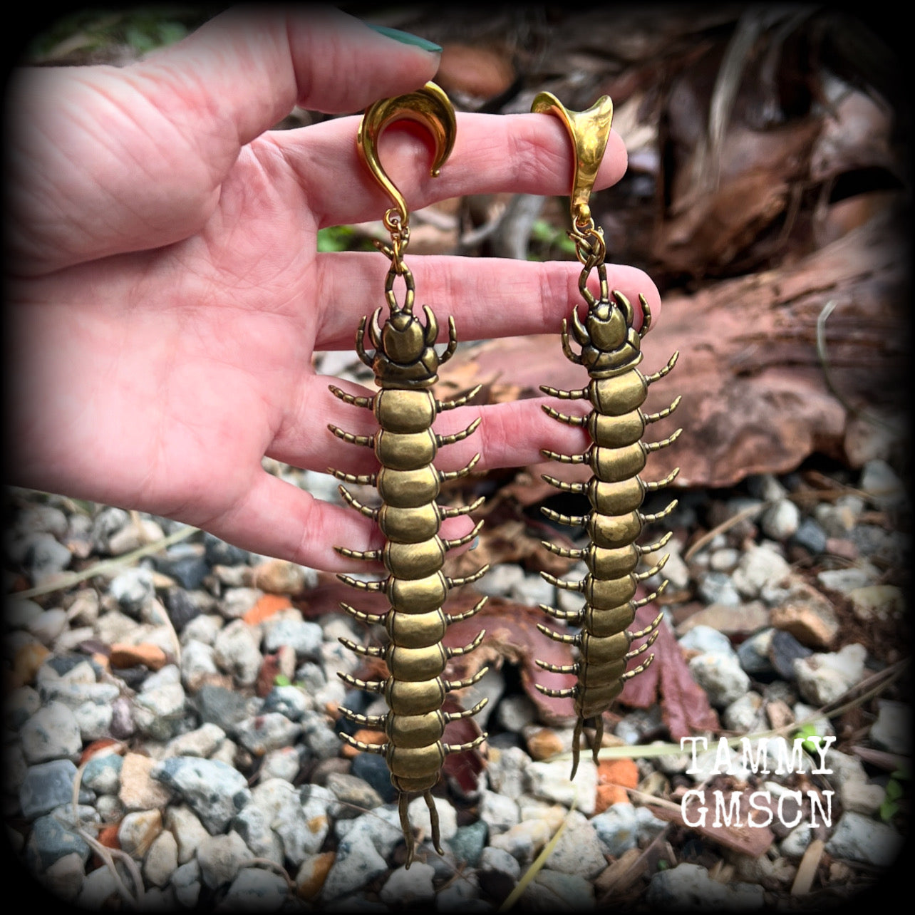These awesome brass centipede ear hangers feature gorgeous brass invertebtrate pendants, measuring just over 17cms from tip to tip, and weighing approx 55 grams each, nice and dangly with a nice bit of weight.

This pair has been made on 5/8” gauge (16mm) titanium coated surgical steel saddles, suitable for stretched lobes.

