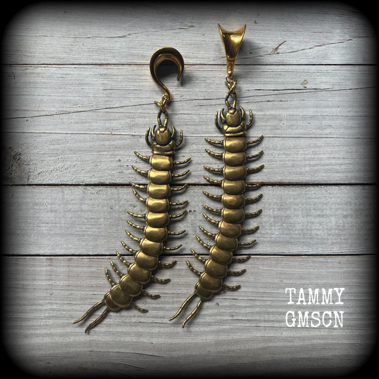 These awesome brass centipede ear hangers feature gorgeous brass invertebtrate pendants, measuring just over 17cms from tip to tip, and weighing approx 55 grams each, nice and dangly with a nice bit of weight.

This pair has been made on 5/8” gauge (16mm) titanium coated surgical steel saddles, suitable for stretched lobes.

