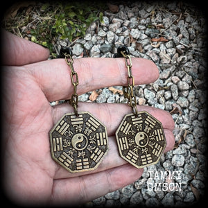 These unique tunnel dangles feature brass Tai Shang Lao Jun pendants, a type of Chinese Taoist pendant with the front side featuring the Chinese Bagua for protection, while the other side showcases a Chinese Taoism design for great protection.  🔥 These pendants are associated with Tai Shang Lao Jun, a prominent deity in Taoism, and are believed to offer protection and good fortune🔥  This pair weighs approx 10 grams each, and measuring 6.5cms from tip to tip.