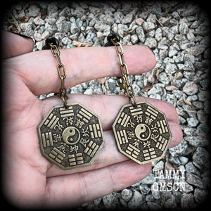 These unique tunnel dangles feature brass Tai Shang Lao Jun pendants, a type of Chinese Taoist pendant with the front side featuring the Chinese Bagua for protection, while the other side showcases a Chinese Taoism design for great protection.  🔥 These pendants are associated with Tai Shang Lao Jun, a prominent deity in Taoism, and are believed to offer protection and good fortune🔥  This pair weighs approx 10 grams each, and measuring 6.5cms from tip to tip.