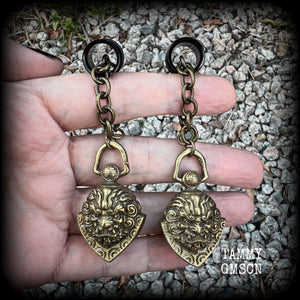 These unique tunnel dangles feature brass lion guardian bells, used in Tibetan Buddhism,  weighing approx 20 grams each, and measuring 8.5cms from tip to tip.  ✨ The ball inside the bell that rings has been disabled so these earrings wont make noise as you go about your day.