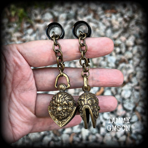 These unique tunnel dangles feature brass lion guardian bells, used in Tibetan Buddhism,  weighing approx 20 grams each, and measuring 8.5cms from tip to tip.  ✨ The ball inside the bell that rings has been disabled so these earrings wont make noise as you go about your day.