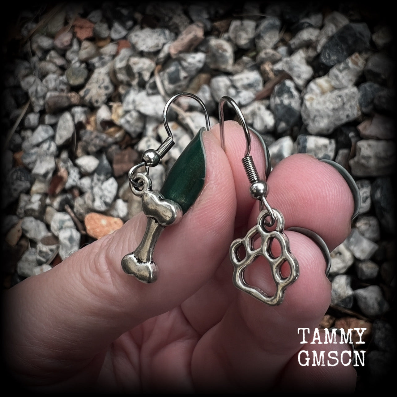 These adorable earrings feature cute classic antique silver dog bone and paw print charms, measuring just under 3cms from tip to tip, and weighing only a gram or two each.

This pair has been made with stainless steel french hooks, suitable for pierced ears.