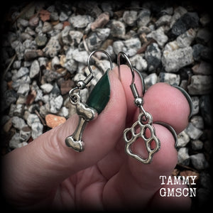 These adorable earrings feature cute classic antique silver dog bone and paw print charms, measuring just under 3cms from tip to tip, and weighing only a gram or two each.

This pair has been made with stainless steel french hooks, suitable for pierced ears.