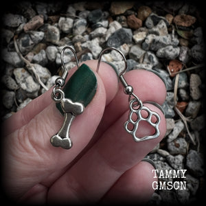 These adorable earrings feature cute classic antique silver dog bone and paw print charms, measuring just under 3cms from tip to tip, and weighing only a gram or two each.

This pair has been made with stainless steel french hooks, suitable for pierced ears.